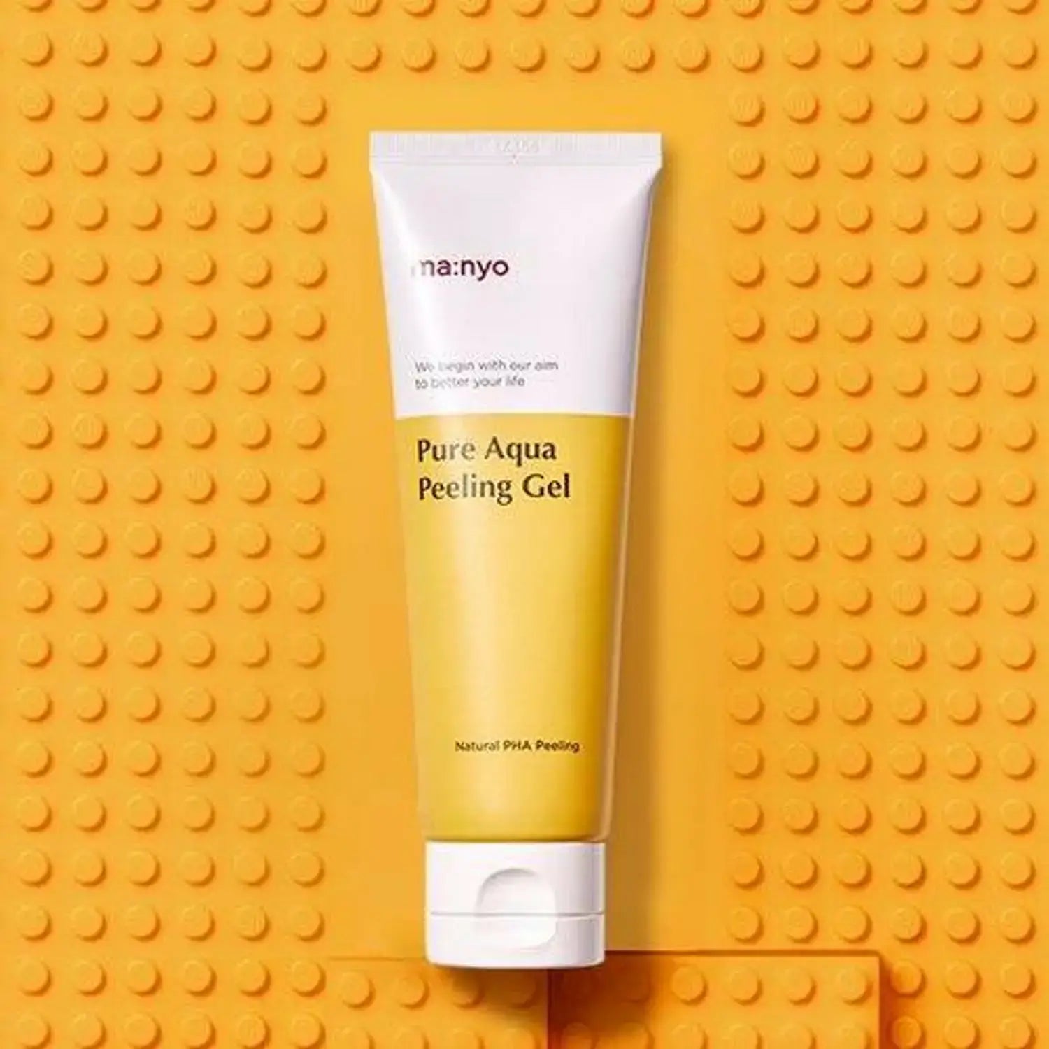 MANYO Pure Aqua Peeling Gel 120ml tube on textured yellow background