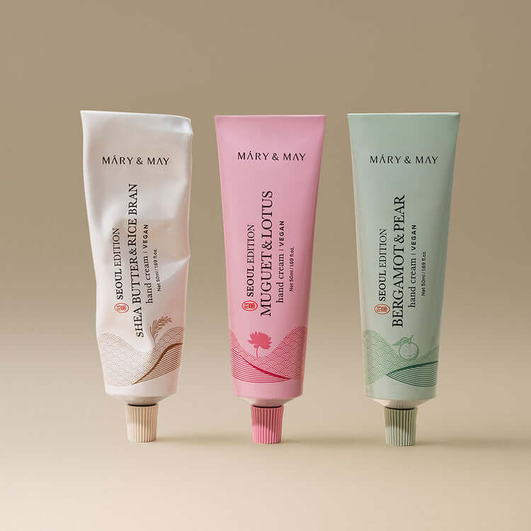 MARY & MAY Hand Cream Trio Set showcasing three tubes: Shea Butter & Rice Bran, Mugget & Lotus, Bergamot & Pear on a neutral background.