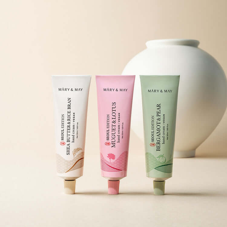 MARY & MAY Hand Cream Trio Set featuring Shea Butter, Mugwort & Lotus, and Bergamot & Pear creams against a neutral background