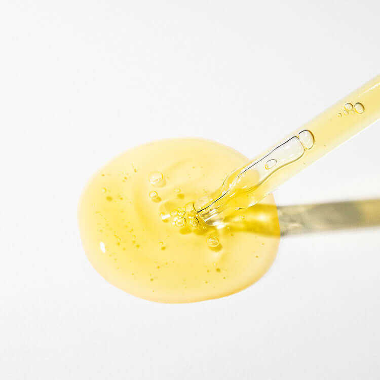 MARY & MAY Idebenone+Blackberry Complex Serum with dropper and serum texture on white background