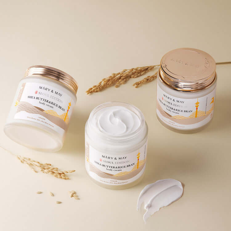 MARY & MAY Shea Butter & Rice Bran body Cream with jars and cream texture shown on a clean surface