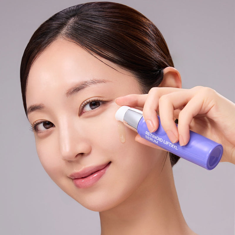Woman applying MEDIANSWER Retinoid Liftsil Serum 30ml to her face for skincare routine.