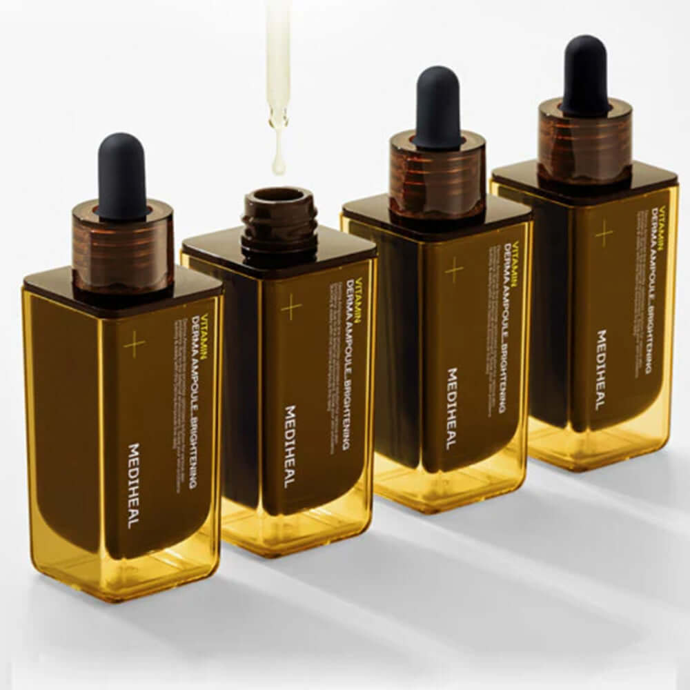 Four bottles of MEDIHEAL Vitamin Derma Ampoule Blemish Whitening 50ml with droppers, showcasing the skin whitening serum.