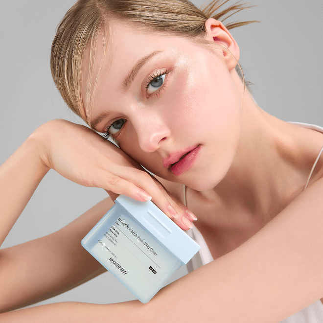 Woman holding MEDITHERAPY Niacin X BHA Pore Mild Clear Pad 60 sheets, showcasing skincare product for pore care and complexion improvement.