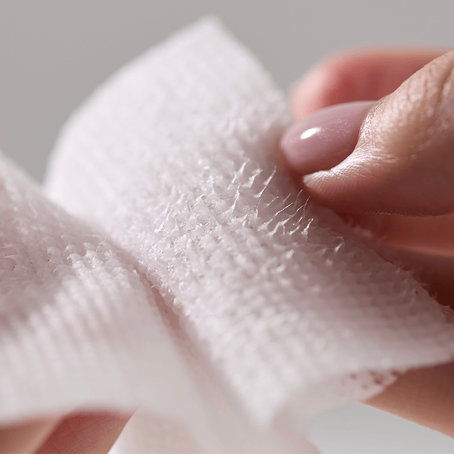 Close-up of hand holding MEDITHERAPY Niacin X BHA Pore Mild Clear Pad 60 sheets, showing texture and detail.