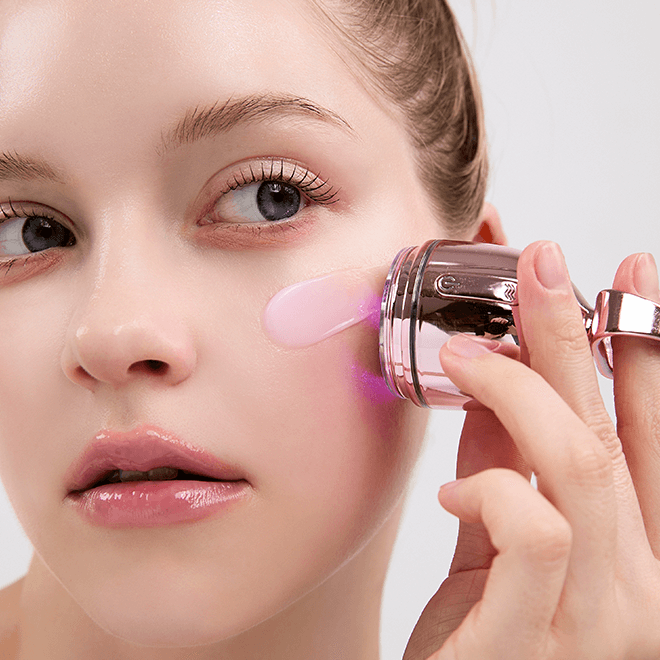Woman using MEDITHERAPY Philizio Pink Retinol Volume Cream 50ml + EMS Device for skincare routine.