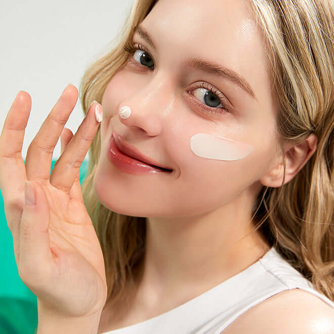 Woman applying MEDITHERAPY Posera Real Bifida Cream 50ml to her face, demonstrating skincare routine.