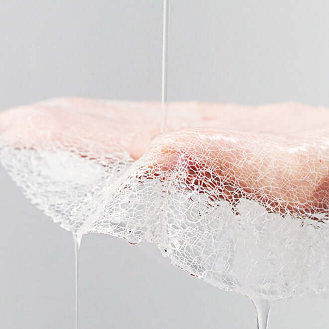 Close-up of MEDITHERAPY Wrinkle Fit Neck Mask texture with serum application.