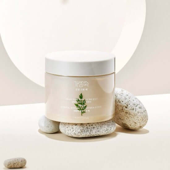 MISSHA Artemisia soothing spot pack displayed on rocks with soft lighting, showcasing product packaging and natural ingredients.
