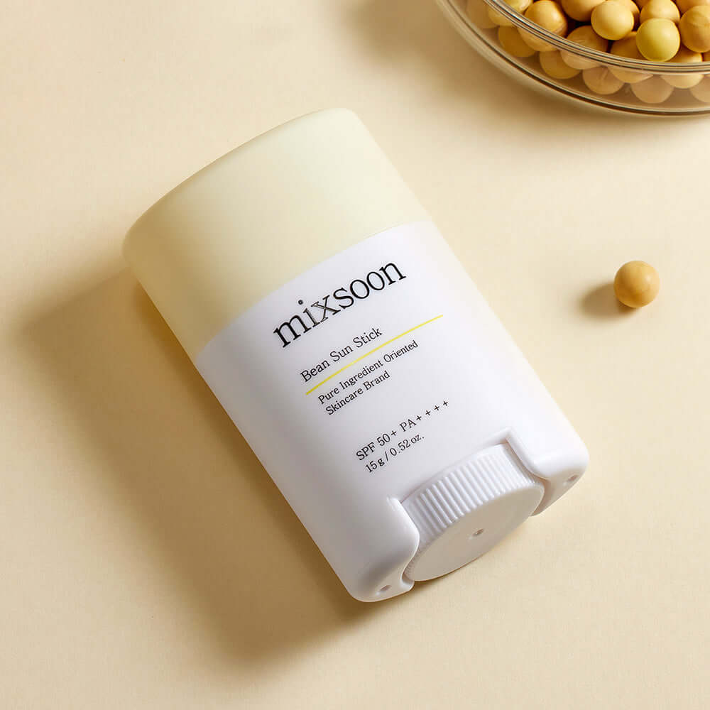 MIXSOON Bean Sun Stick with SPF 50+, featuring natural ingredients for sun protection, displayed on a beige background with beans.