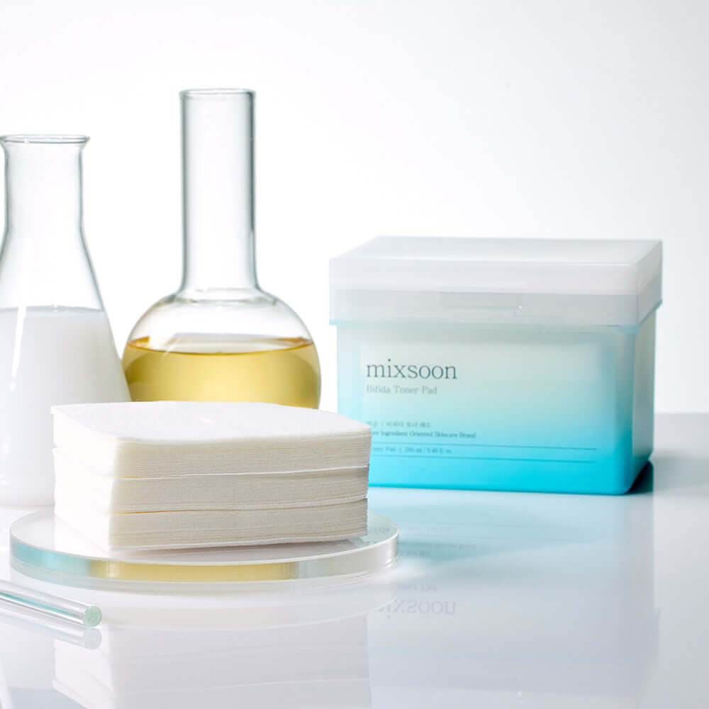 MIXSOON Bifida Toner Pad next to laboratory glassware for skincare routine