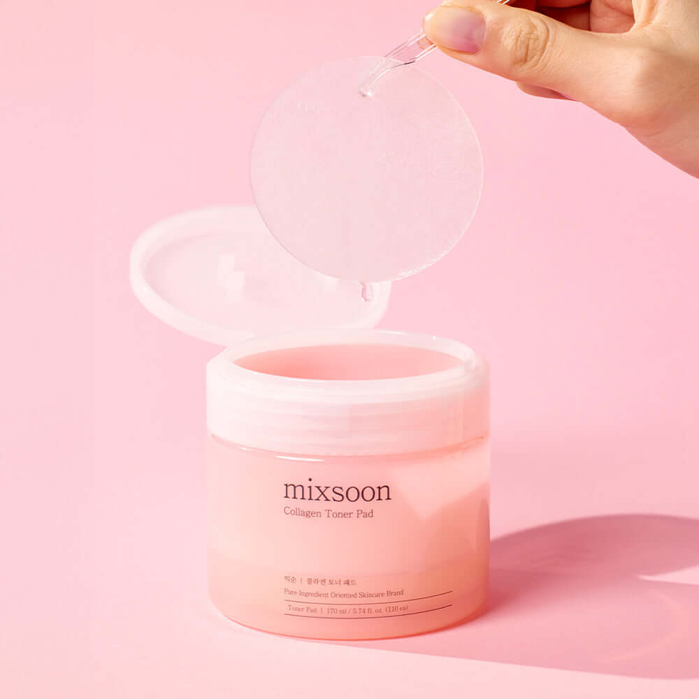 MIXSOON Collagen Toner Pad being held above a pink jar on a pink background