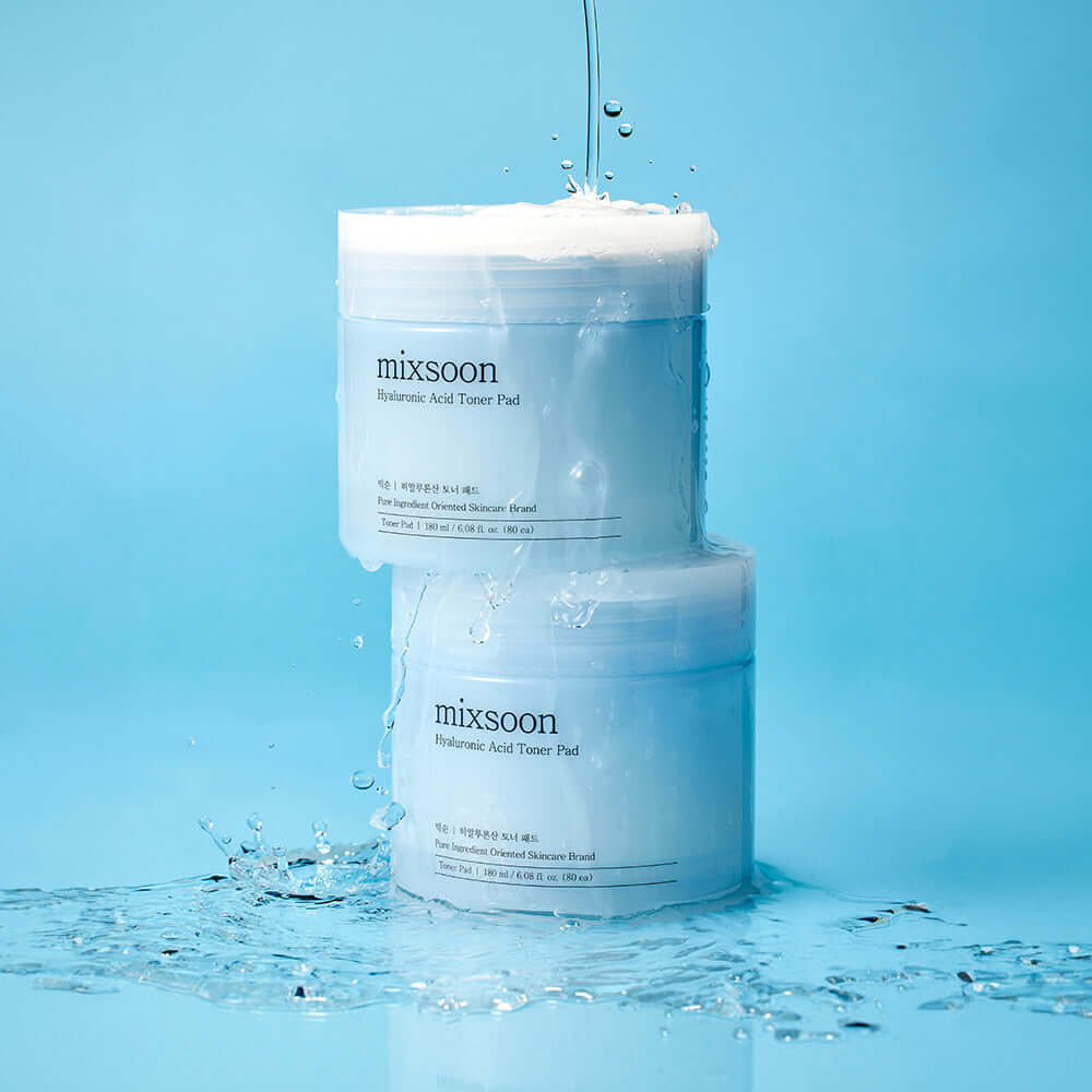 MIXSOON Hyaluronic Acid Toner Pad containers with water splashes on blue background