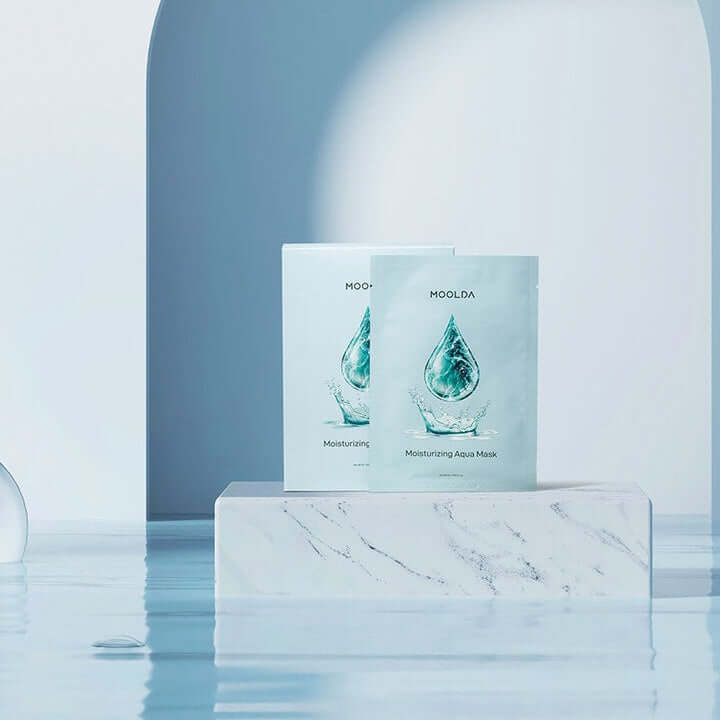 MOOLDA Moisturizing Aqua Mask packaging displayed on a marble block with a serene water backdrop.