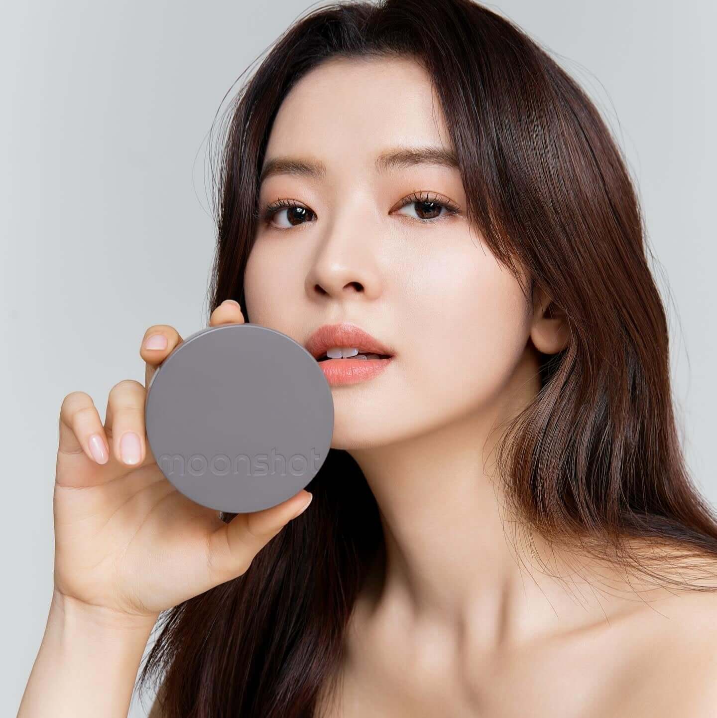 Woman holding MOONSHOT Conscious Fit Matte Cushion Foundation
