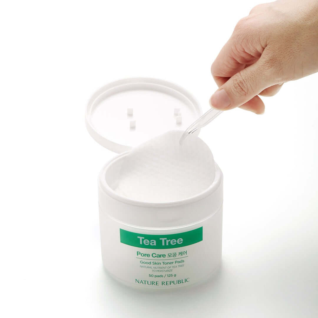 NATURE REPUBLIC Good SKin Tea Tree Ampoule Toner Pads 125g container with a hand picking a pad, skincare product for pore care