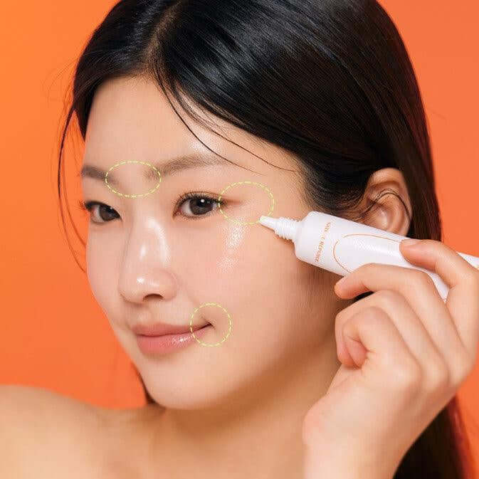 Woman applying NATURE REPUBLIC Kombucha Black Tea Eye Cream 30ml on her face for skincare routine