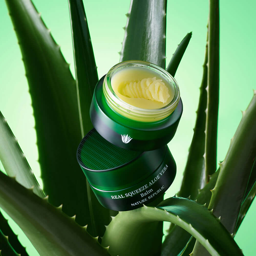 NATURE REPUBLIC Real Squeeze ALoe Vera Balm 25g displayed among aloe vera leaves