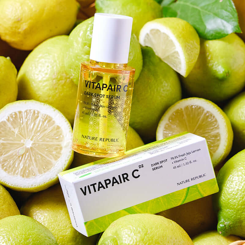 NATURE REPUBLIC Vitapair C SPot Serum 45ml bottle and packaging surrounded by fresh lemons