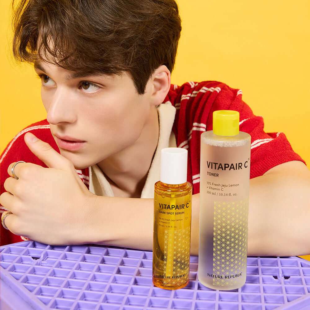 NATURE REPUBLIC Vitapair C Spot Serum 90ml Large Capacity 90ml with person and Vitapair C Toner displayed on purple surface.