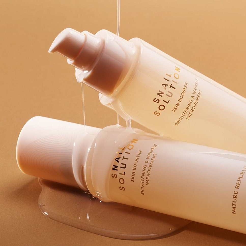 NATURE REPUBLIC Snail Solution Skin Booster 130ml – Gentleman Korea product shot with two pump bottles and snail serum glistening