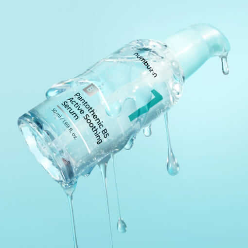 NUMBUZIN No.1 Pantothenic B5 Active Soothing Serum bottle dripping with water on a blue background
