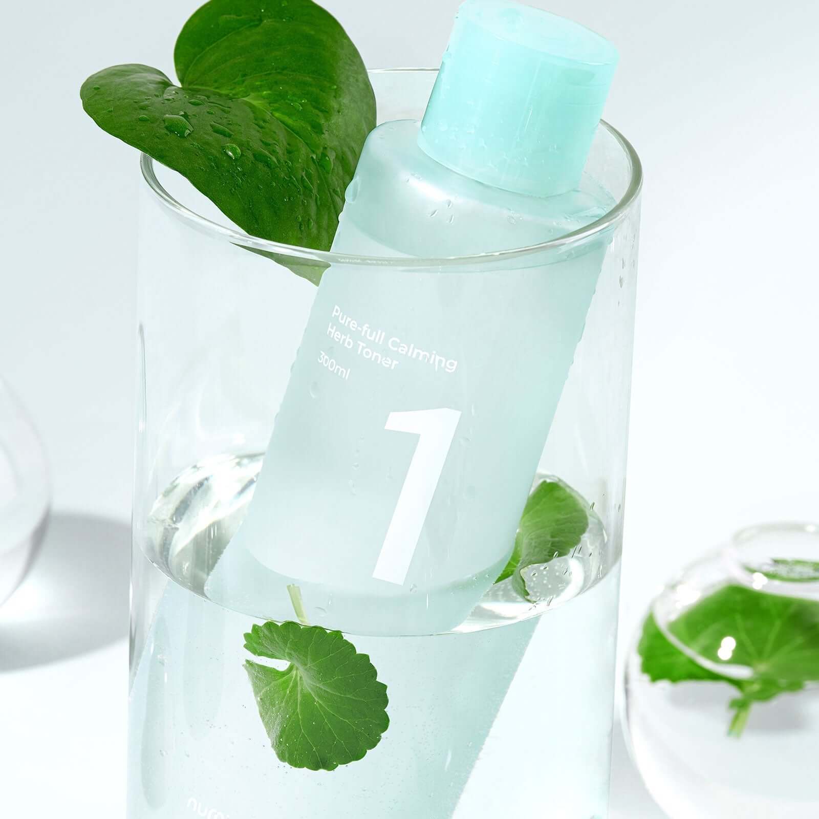 NUMBUZIN No.1 Pure-Full Calming Herb Toner in glass with leaves, soothing facial care product.
