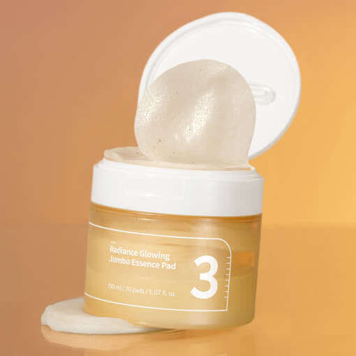 NUMBUZIN No.3 Radiance Glowing Jumbo Essence Pad on an orange background