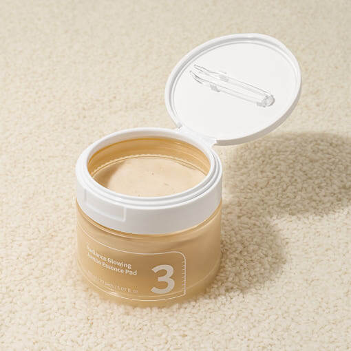 NUMBUZIN No.3 Radiance Glowing Jumbo Essence Pad in open jar on beige surface