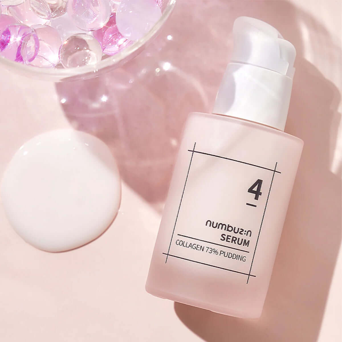 NUMBUZIN No.4 Collagen 73% Pudding Serum bottle on pink background with gel beads.