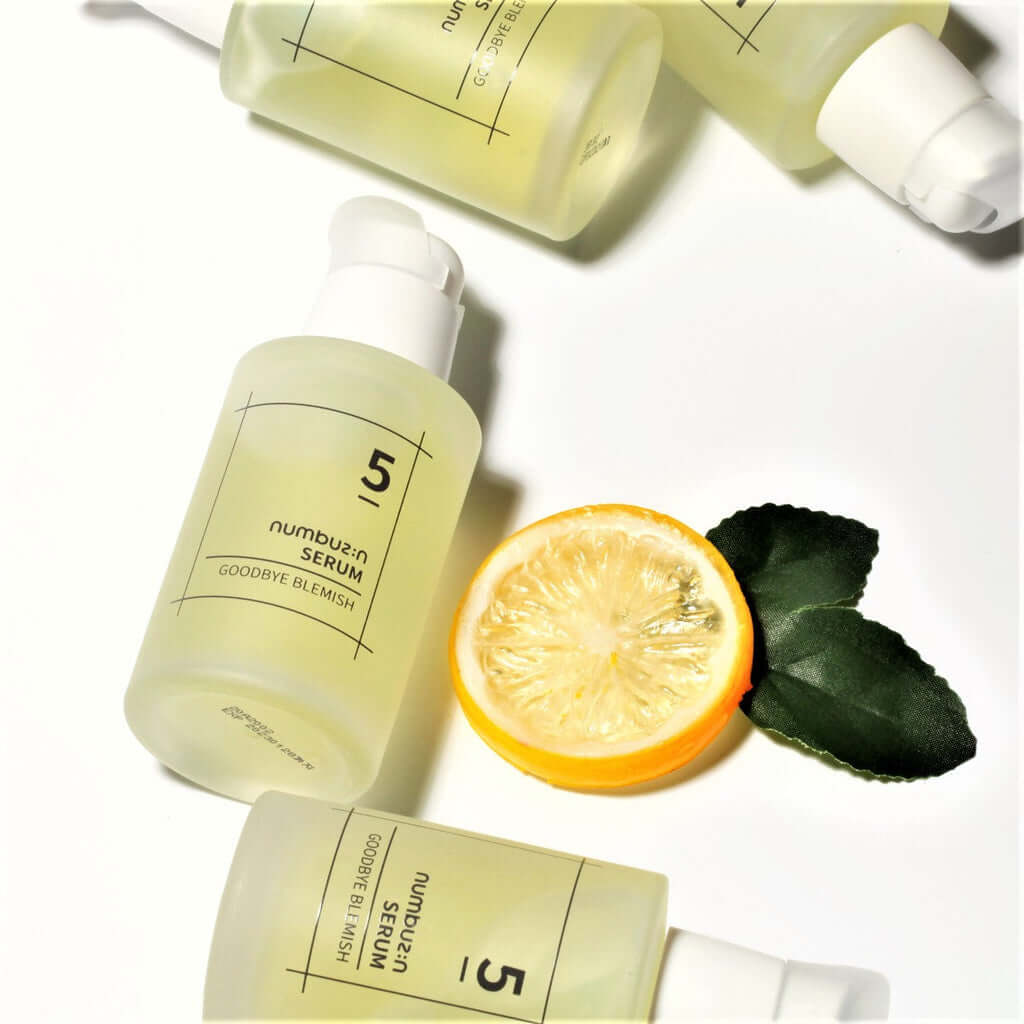NUMBUZIN No.5 Goodbye Blemish Serum bottle with sliced lemon on white background
