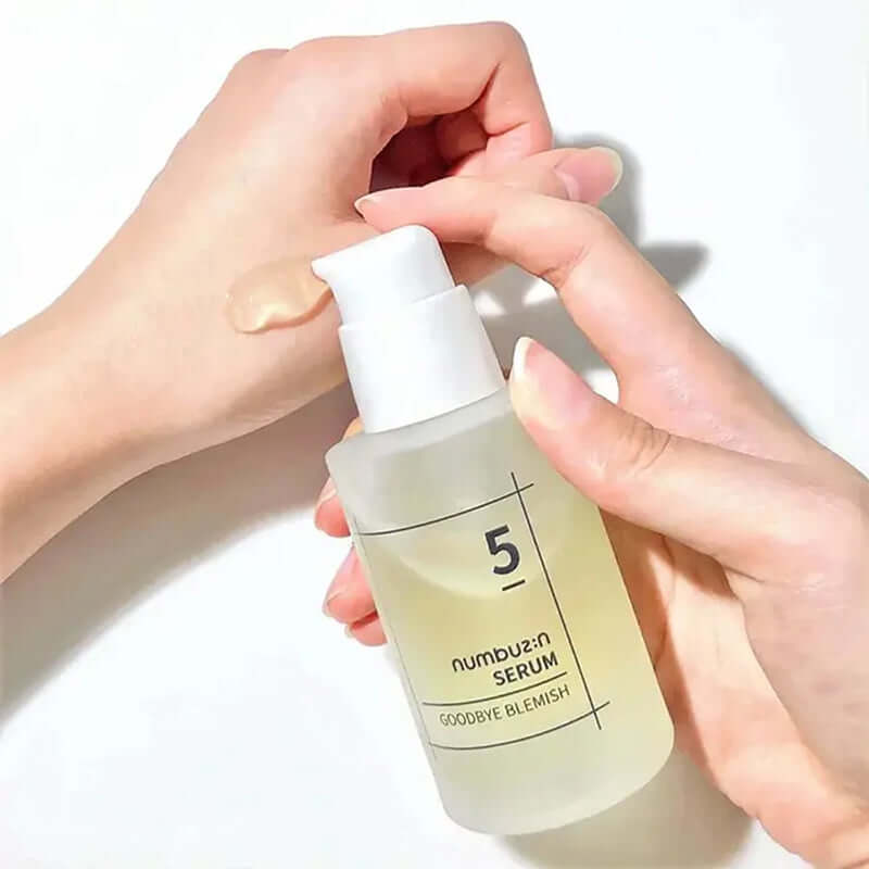 NUMBUZIN No.5 Goodbye Blemish Serum being applied to hand for skincare routine.