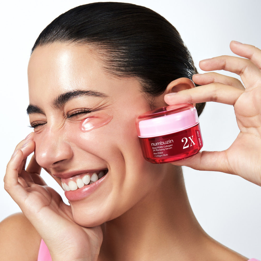 Woman using NUMBUZIN No.2 Rose PDRN Collagen 2X Plumping Serum 30ml near her eye for youthful skin.