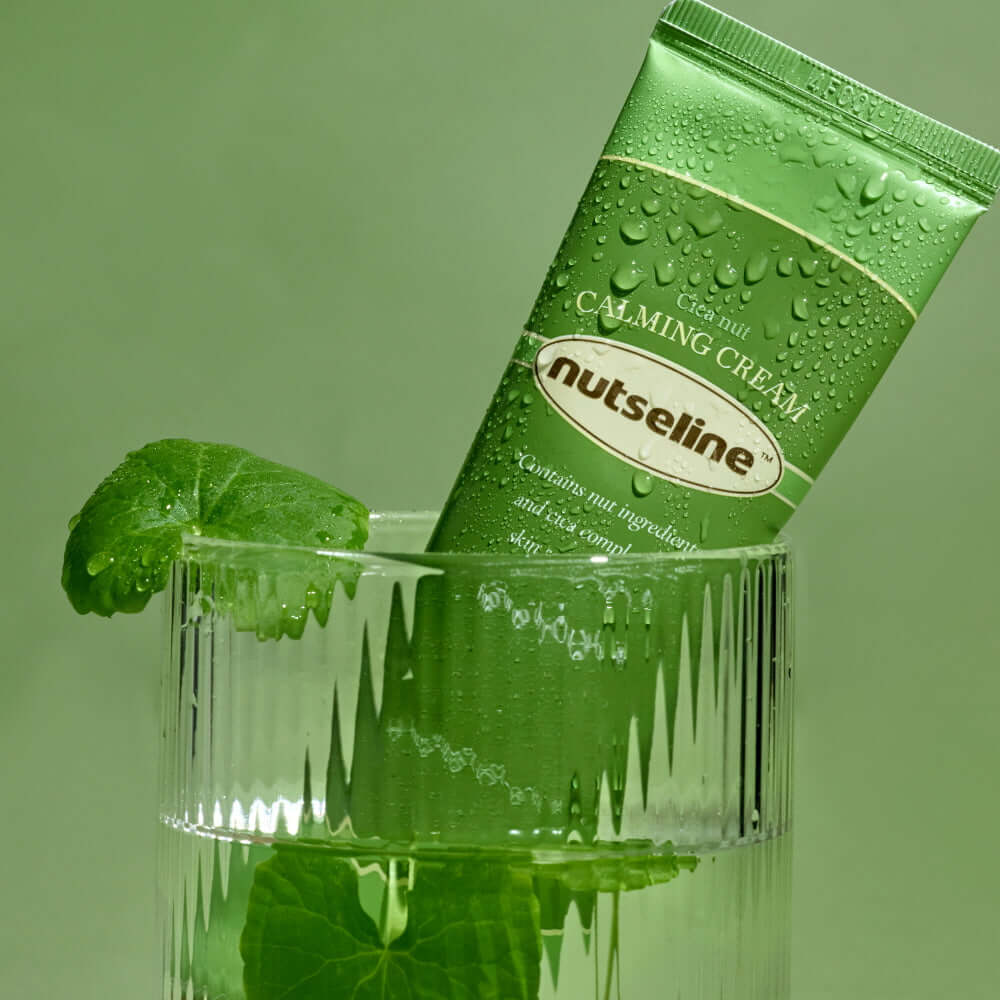 NUTSELINE Cica Nut Calming Cream 60ml in a decorative glass with leaves, emphasizing the soothing and natural qualities of the skincare product.