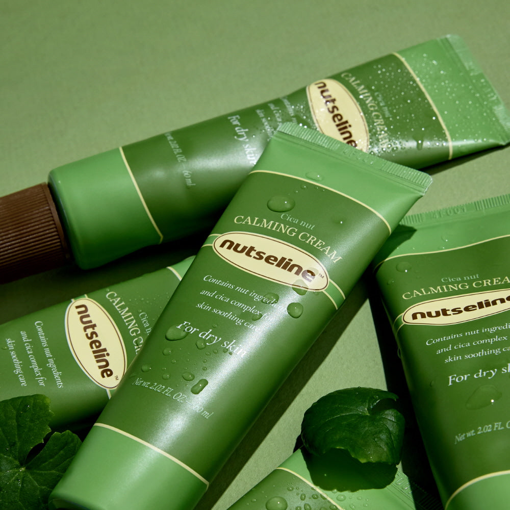 NUTSELINE Cica Nut Calming Cream 60ml tubes displayed on green background, highlighting skincare product for dry skin.