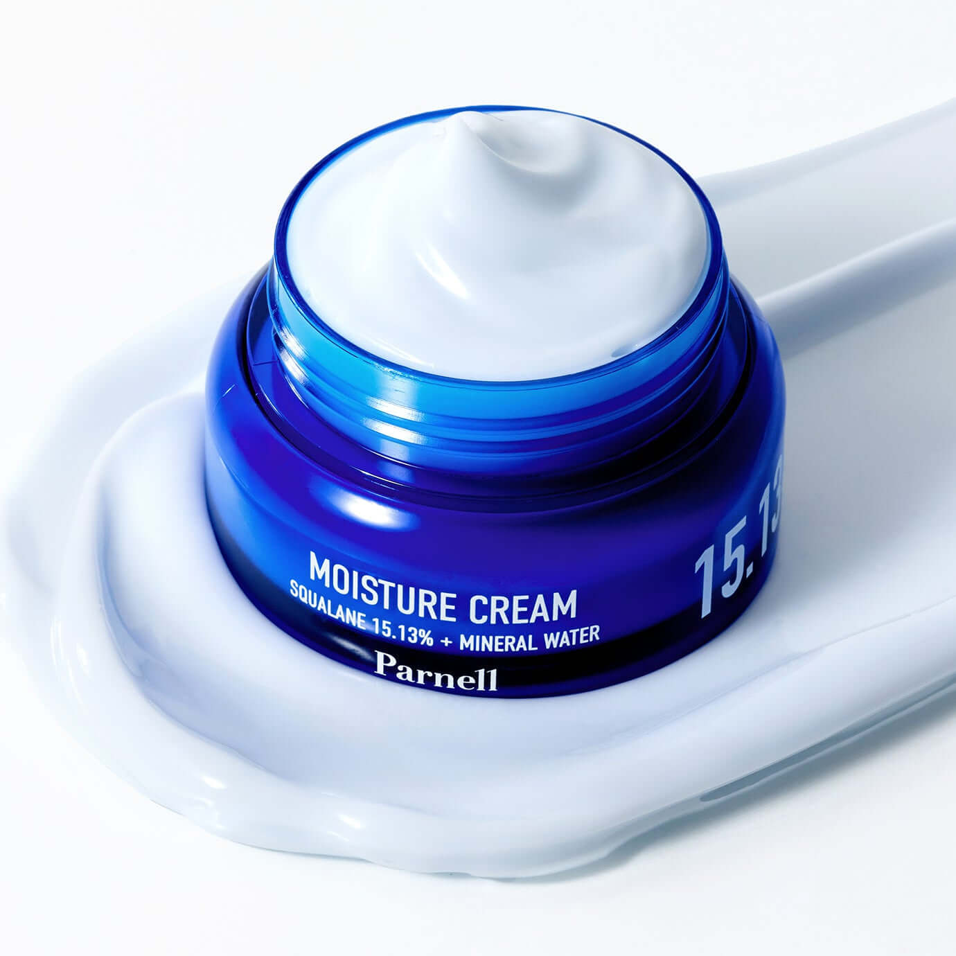PARNELL Squalane 15.13 Mineral Water Moisture Cream 50ml in open blue jar with cream texture on white background.