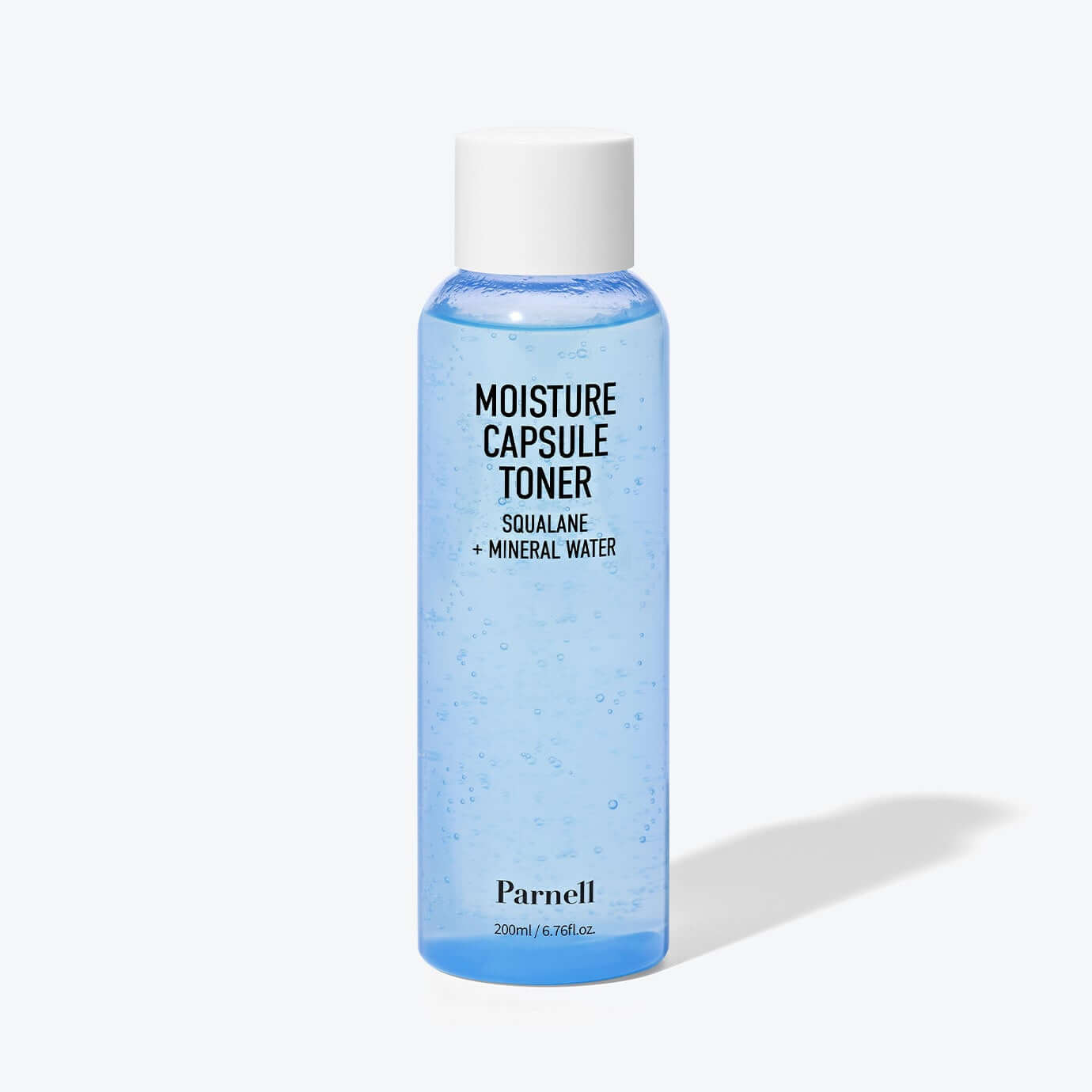 Bottle of PARNELL Squalane Mineral Water Moisture Capsule Toner 200ml showing blue liquid with white cap on a neutral background.