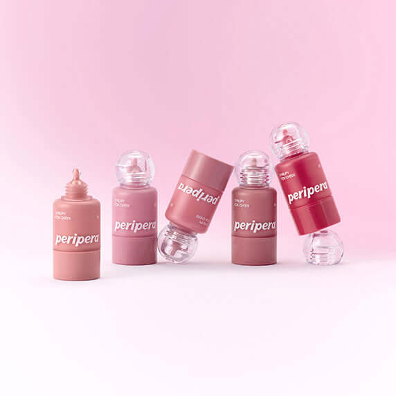 PERIPERA Syruppy Talk Cheek bottles on a pink background, featuring various shades and spill-proof design.