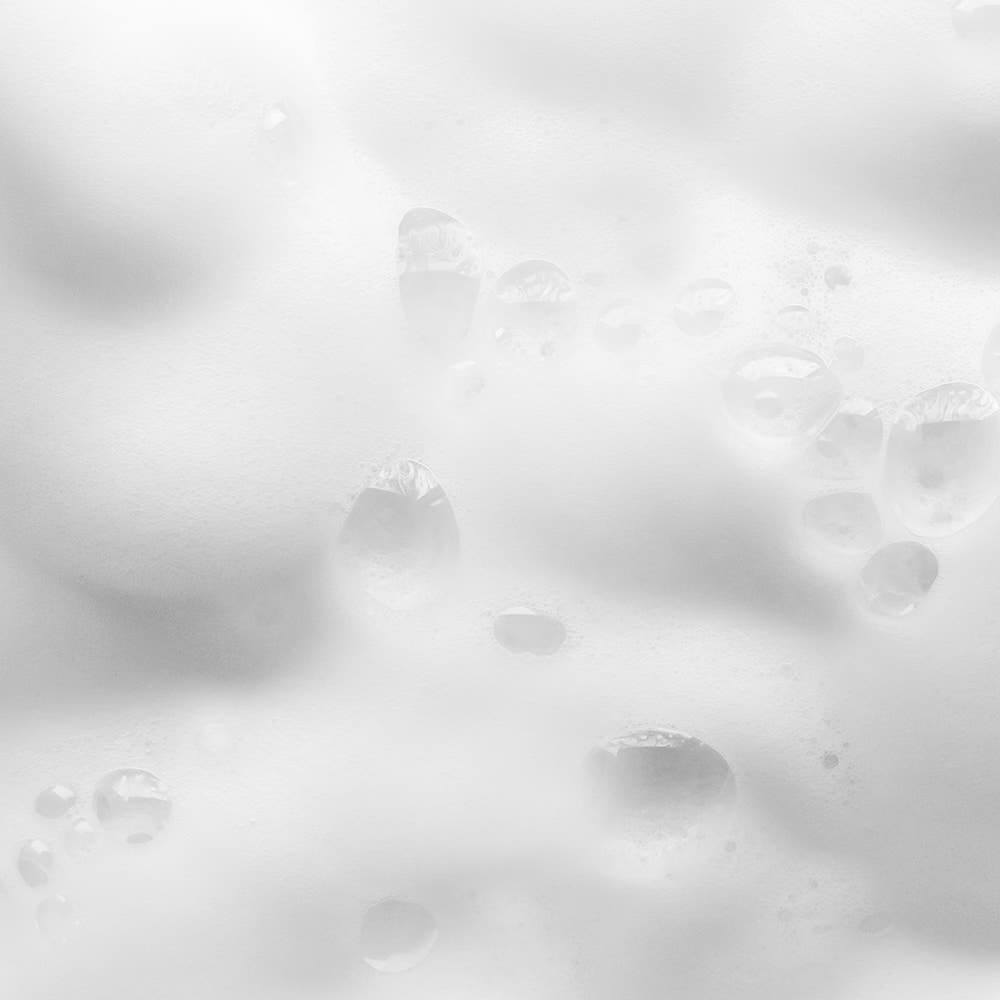 Close-up of foamy lather from PYUNKANG YUL Ato Mildly Acidic Moisturizing Body Wash 590ml showing moisturizing properties.