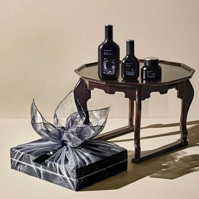 PYUNKANG YUL Black Tea Bojigi Gift Set on wooden table with elegant packaging.