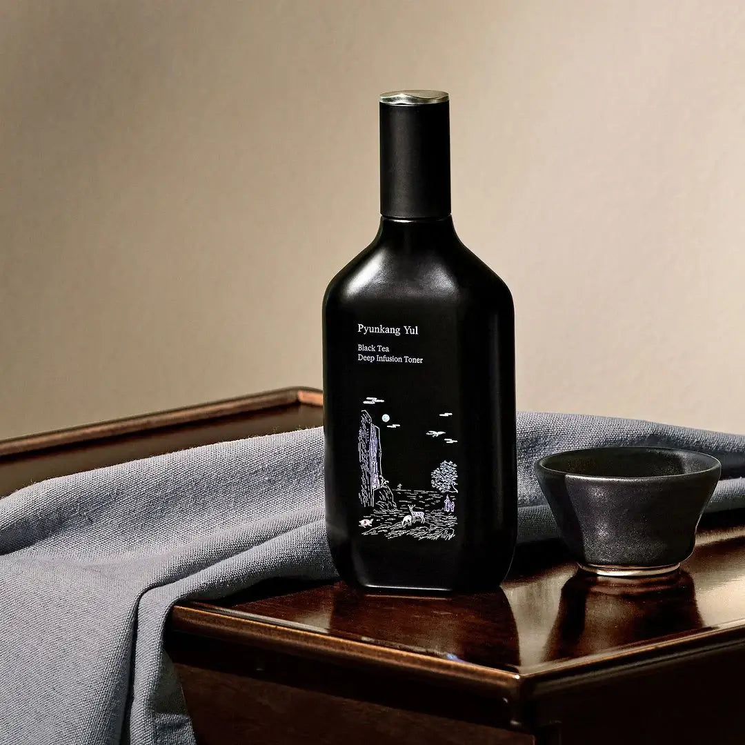 PYUNKANG YUL Black Tea Deep Infushion Toner 130ml bottle on table with cup