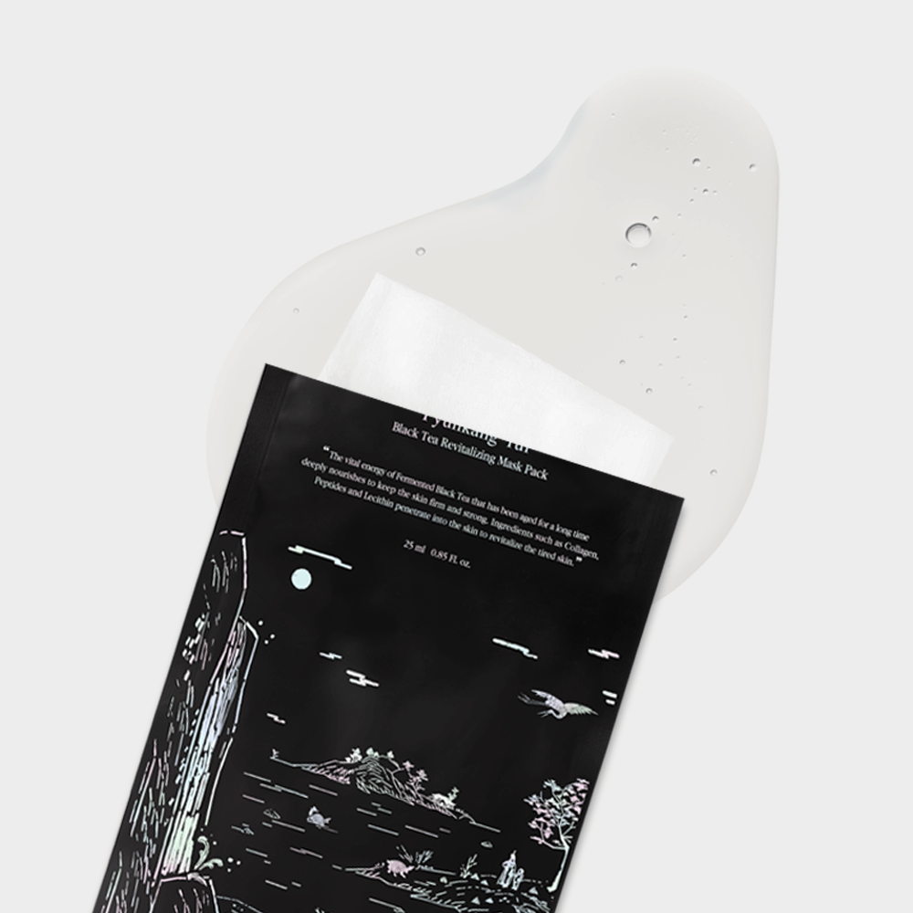 PYUNKANG YUL Black Tea Revitalizing Mask Pack 10 Pieces laying on a white surface with design details visible.