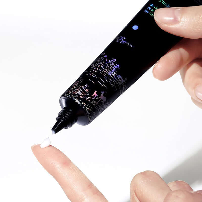 Applying PYUNKANG YUL Black Tea Time Reverse Eye Cream 25ml on fingertip