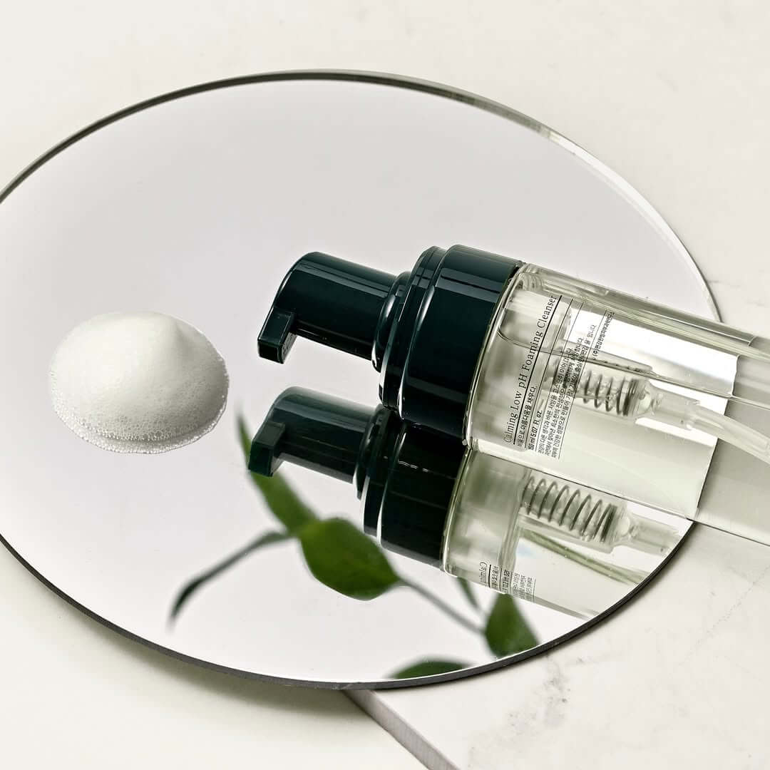 PYUNKANG YUL Calming Low pH Foaming Cleanser 150ml bottle on mirrored surface with foam