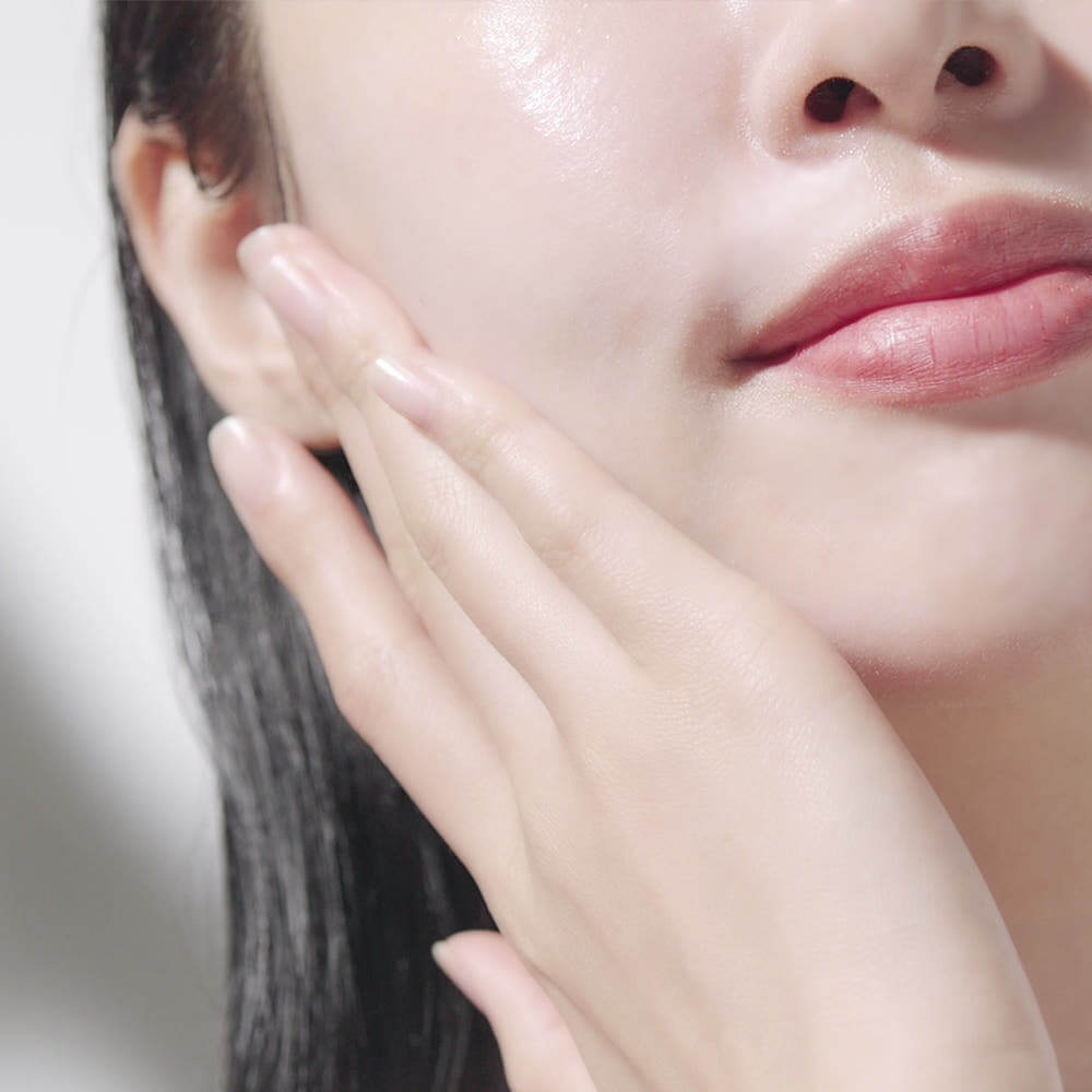 Woman applying PYUNKANG YUL Calming Sun Cream SPF+PA++++ 50ml for skincare