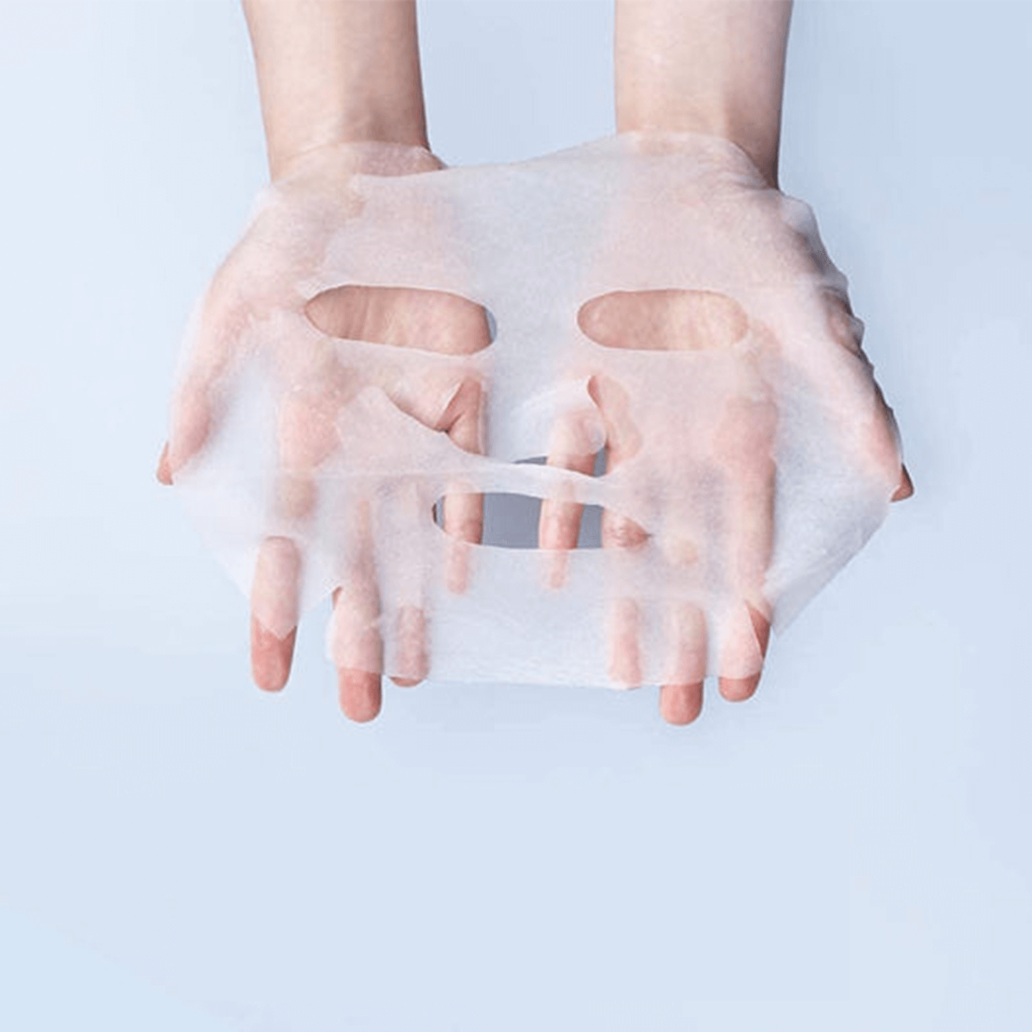 Hands holding a sheet from PYUNKANG YUL High Moisture Essence Mask Pack 10 pieces