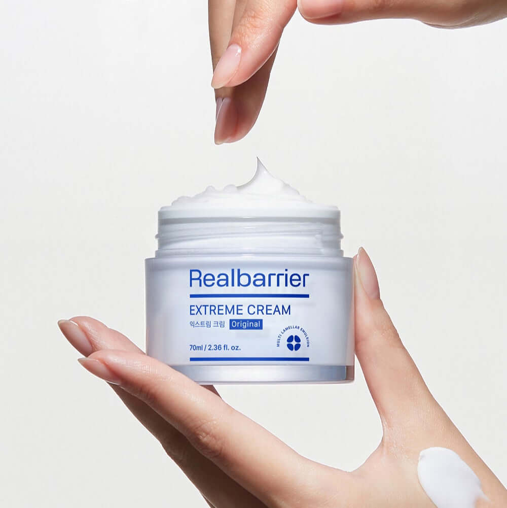 Hand applying REAL BARRIER Extreme Cream 50ml for intense skin moisturization.