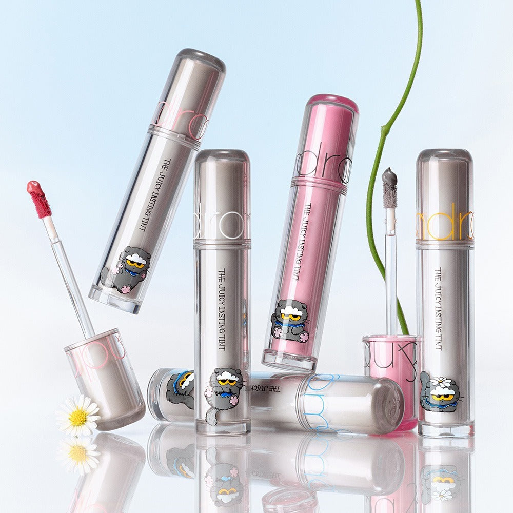 ROMAND x Joanne Friends The Juicy Lasting Tint lipsticks display with floral elements