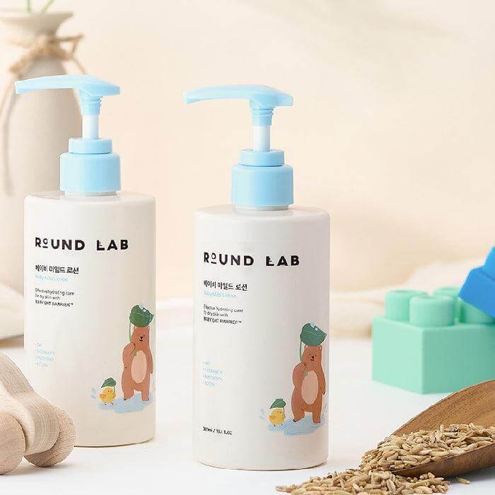 ROUND LAB Baby Mild Lotion 300ml bottles displayed with natural ingredients in a soft setting.