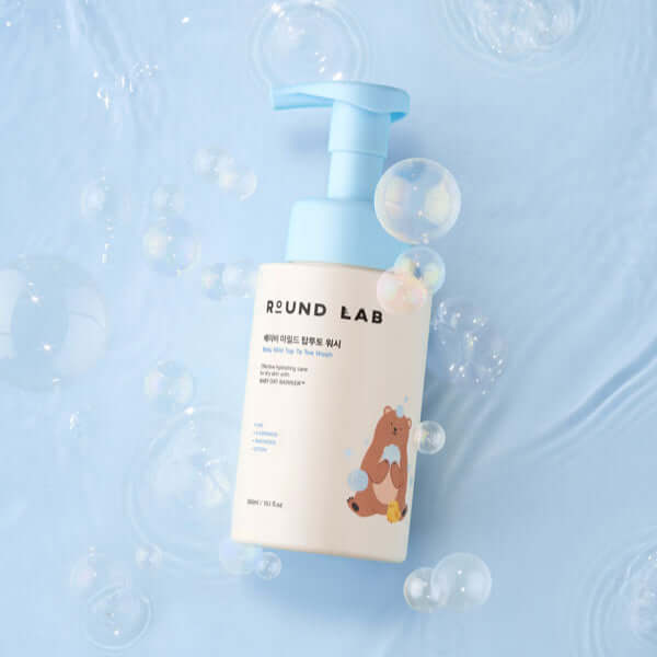 ROUND LAB Baby Mild Top To Toe Wash 300ml bottle with bubbles background